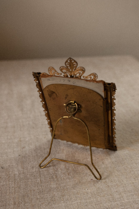 Antique ornate brass case frame