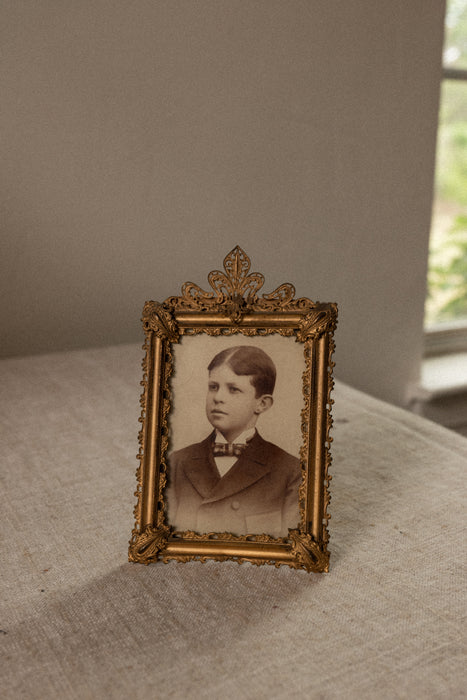 Antique ornate brass case frame
