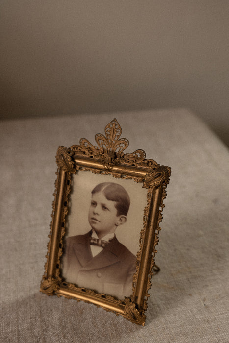 Antique ornate brass case frame